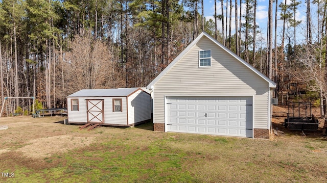 detached garage featuring a storage shed