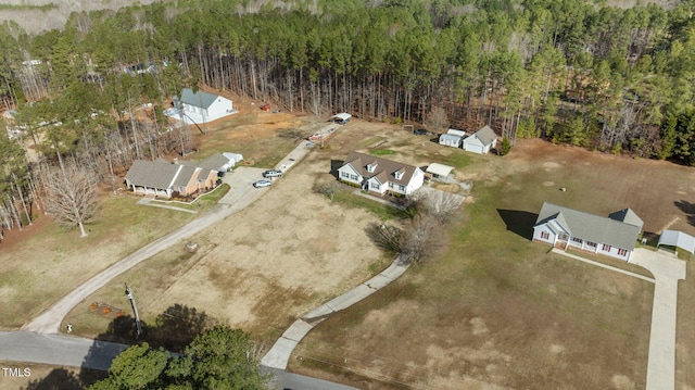 birds eye view of property with a view of trees