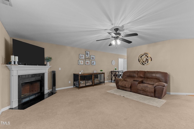 living room featuring visible vents, baseboards, a fireplace, and carpet flooring