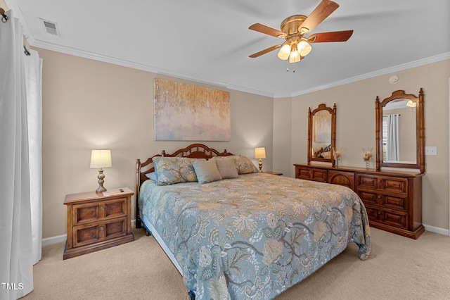 carpeted bedroom featuring ceiling fan, visible vents, baseboards, and ornamental molding