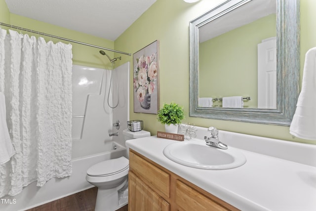 full bath with shower / bathtub combination with curtain, toilet, vanity, a textured ceiling, and wood finished floors