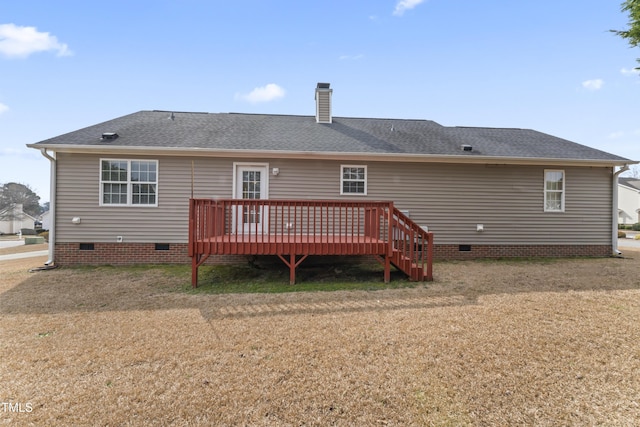 rear view of property with a shingled roof, crawl space, a lawn, and a chimney