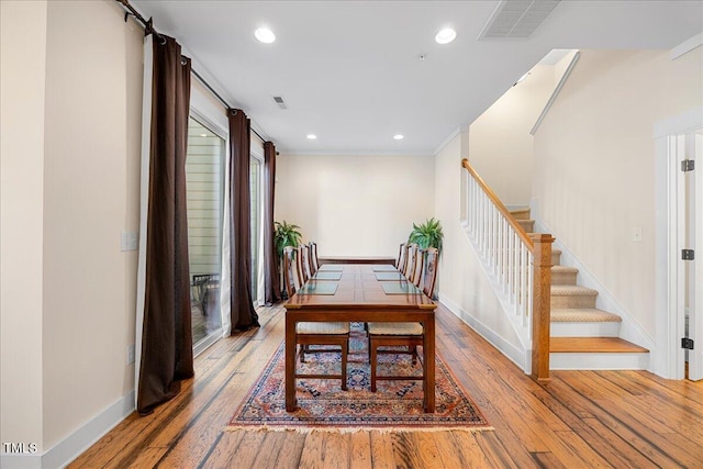 dining space featuring recessed lighting, visible vents, stairway, and wood finished floors