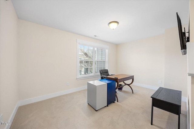 office area featuring light colored carpet and baseboards