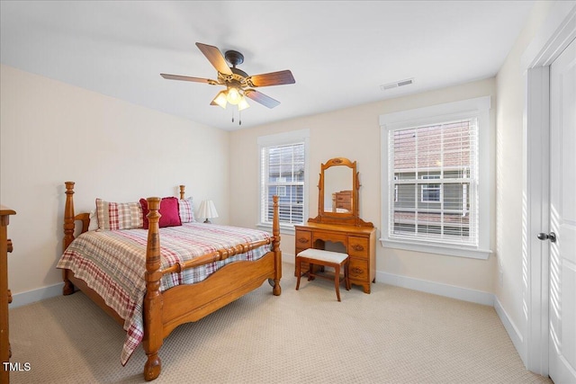 bedroom featuring light carpet, a ceiling fan, visible vents, and baseboards