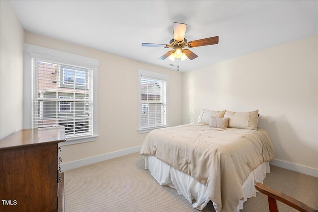 bedroom with baseboards, a ceiling fan, and light colored carpet