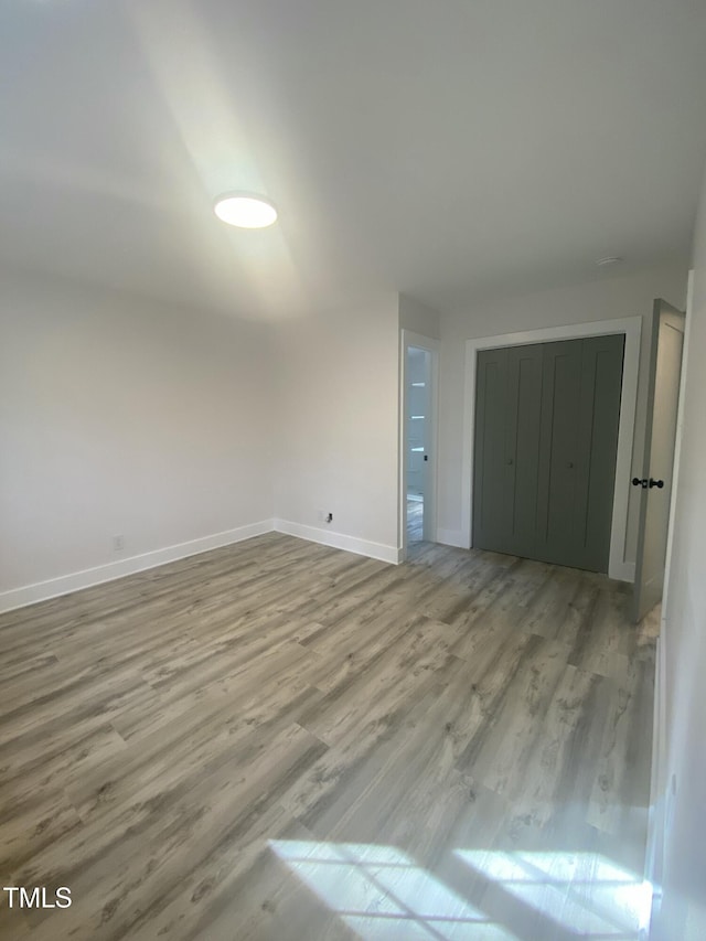 interior space with light wood-type flooring and baseboards