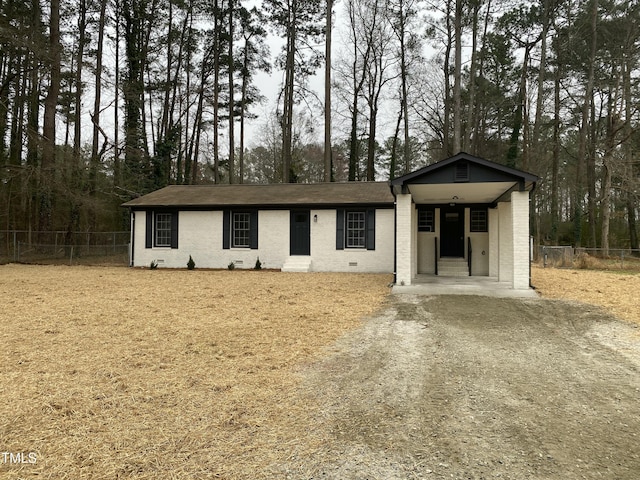 view of front of property with brick siding and fence