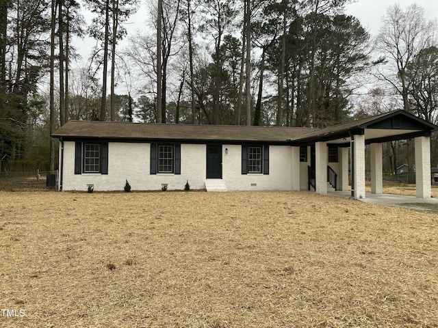 single story home featuring a carport and brick siding