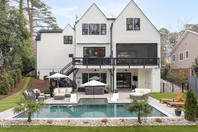 rear view of house with fence, stairway, a patio, outdoor lounge area, and a ceiling fan