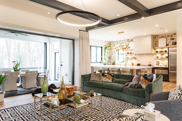 living room with beamed ceiling, recessed lighting, a ceiling fan, and light wood-style floors