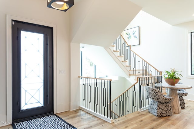 entryway with a healthy amount of sunlight, baseboards, and wood finished floors