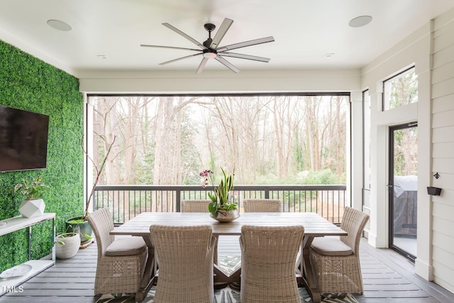 sunroom / solarium featuring ceiling fan