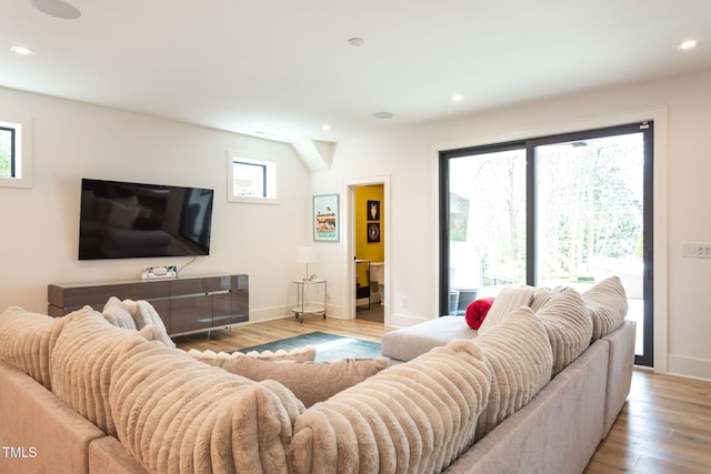 living area with recessed lighting, baseboards, and wood finished floors