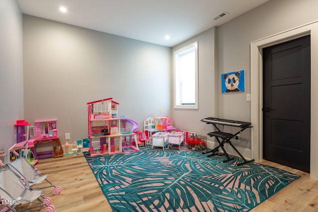 recreation room with visible vents, recessed lighting, and wood finished floors