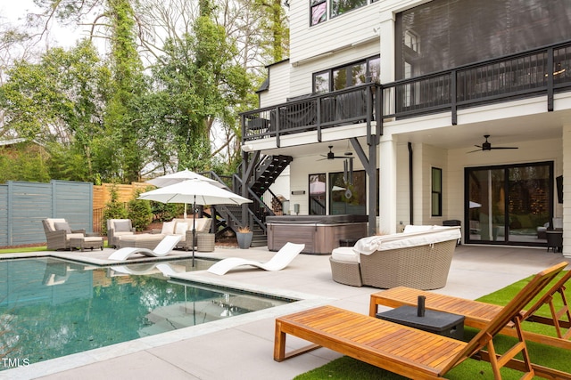 view of pool featuring stairway, fence, a patio area, and a hot tub