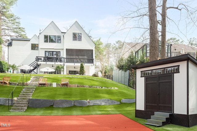 exterior space featuring a storage shed, an outbuilding, stairway, and a lawn