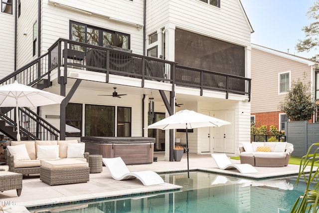 back of property featuring an outdoor living space, a hot tub, stairway, an outdoor pool, and a patio area