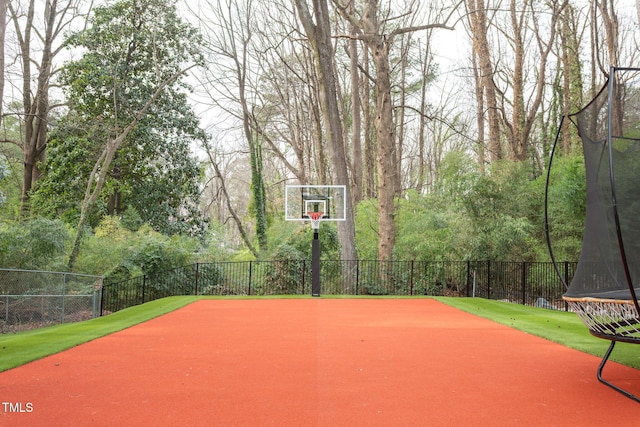 view of basketball court with community basketball court and fence