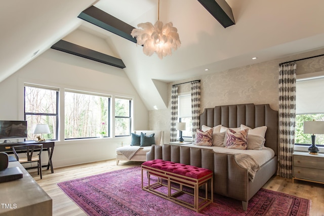 bedroom featuring a notable chandelier, light wood-style flooring, and vaulted ceiling with beams