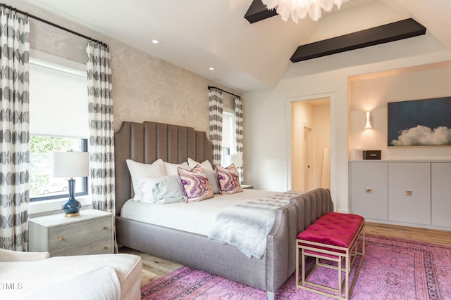 bedroom featuring lofted ceiling and wood finished floors