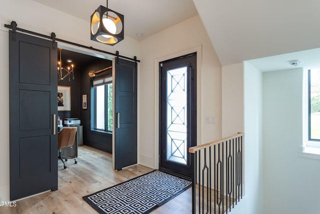 entryway featuring light wood-type flooring and a barn door