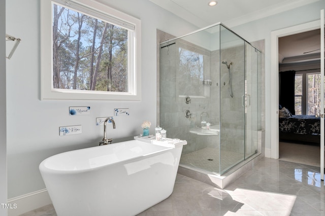 full bath with a stall shower, baseboards, a freestanding tub, and connected bathroom