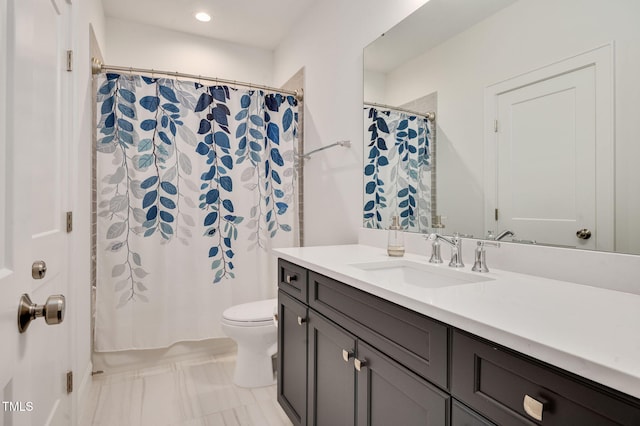 full bathroom featuring curtained shower, vanity, and toilet