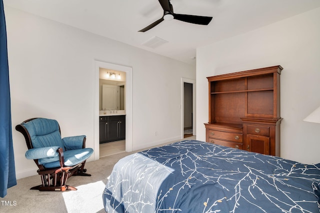 bedroom with light colored carpet, visible vents, ensuite bathroom, a ceiling fan, and baseboards