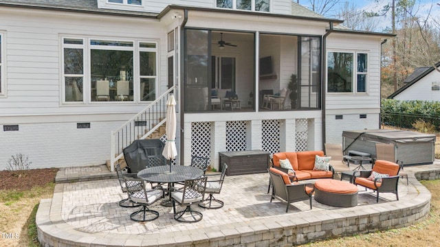 back of property featuring a sunroom, a hot tub, roof with shingles, and a patio