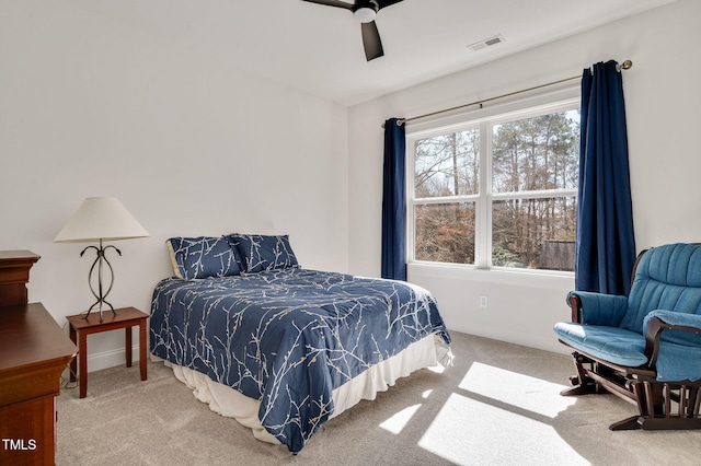 carpeted bedroom with visible vents and ceiling fan