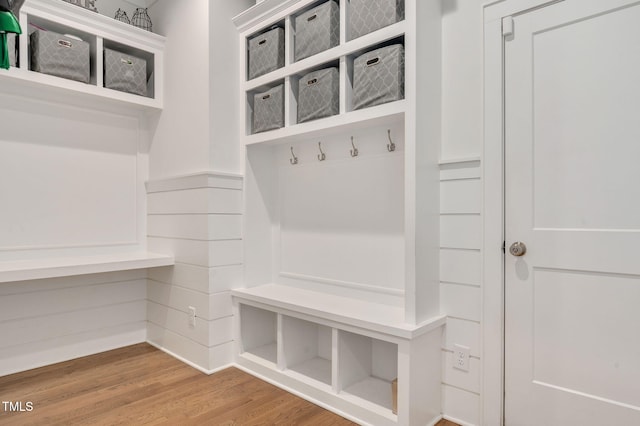 mudroom with a wainscoted wall and wood finished floors