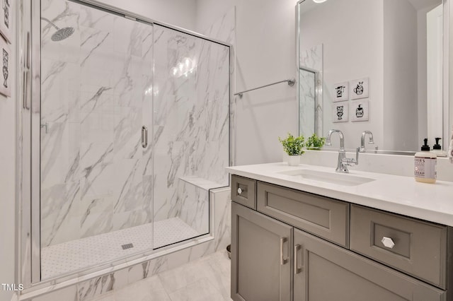 full bathroom with a marble finish shower and vanity