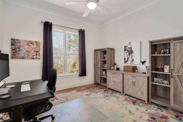 home office with light wood-style floors, ceiling fan, baseboards, and crown molding