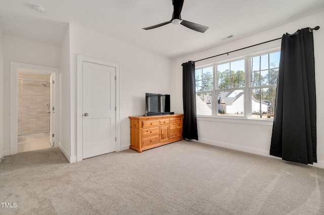 unfurnished bedroom with ceiling fan, ensuite bathroom, light carpet, visible vents, and baseboards