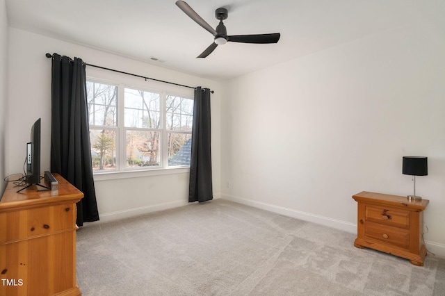 carpeted bedroom with ceiling fan, visible vents, and baseboards