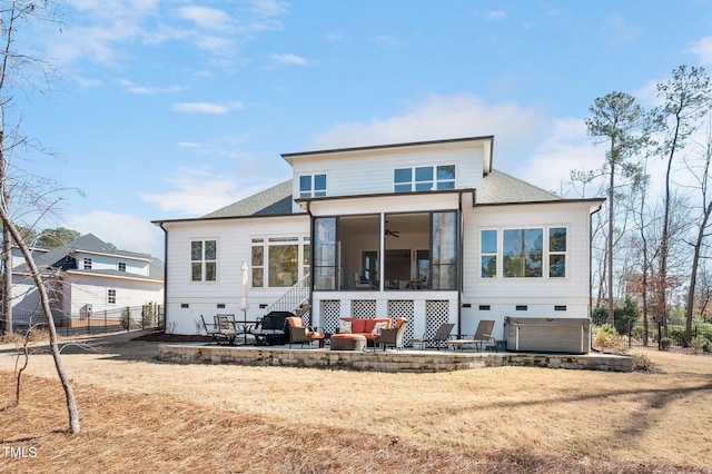 rear view of house featuring a sunroom, a patio area, fence, and roof with shingles