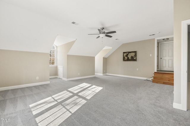 bonus room featuring ceiling fan, baseboards, visible vents, and light colored carpet