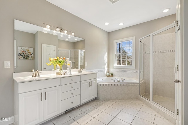 full bath featuring double vanity, a shower stall, a sink, and tile patterned floors