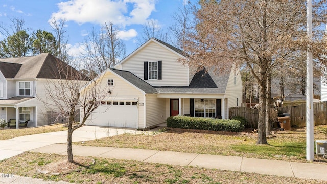 traditional-style house with covered porch, a garage, a shingled roof, fence, and concrete driveway