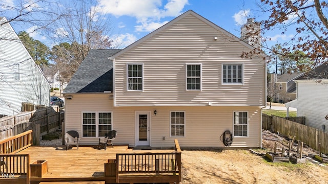 rear view of property with fence private yard, a shingled roof, and a wooden deck