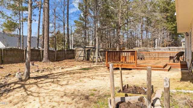 view of yard featuring a fenced backyard and a deck