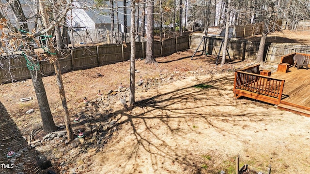 view of yard with a fenced backyard and a deck