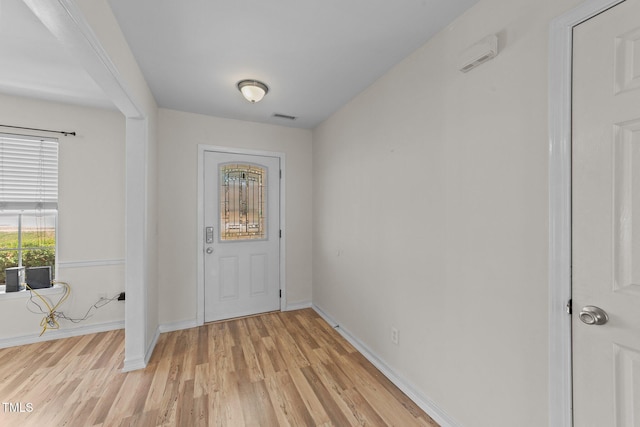 foyer featuring light wood-type flooring, visible vents, and baseboards