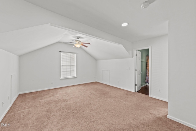 additional living space featuring vaulted ceiling, carpet floors, ceiling fan, and baseboards