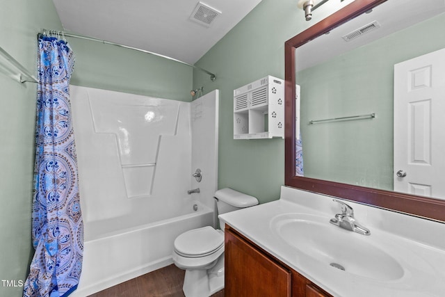 bathroom featuring visible vents, shower / tub combo with curtain, vanity, and toilet