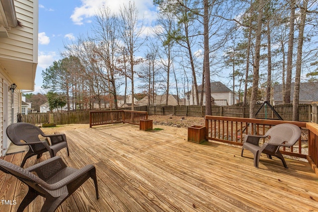 wooden deck featuring a fenced backyard