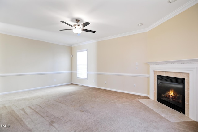 unfurnished living room featuring ceiling fan, a tile fireplace, light carpet, baseboards, and crown molding