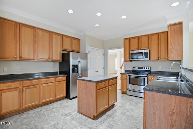 kitchen featuring stainless steel appliances, a sink, a center island, brown cabinetry, and crown molding