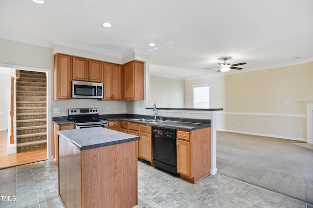 kitchen with appliances with stainless steel finishes, dark countertops, crown molding, and a sink